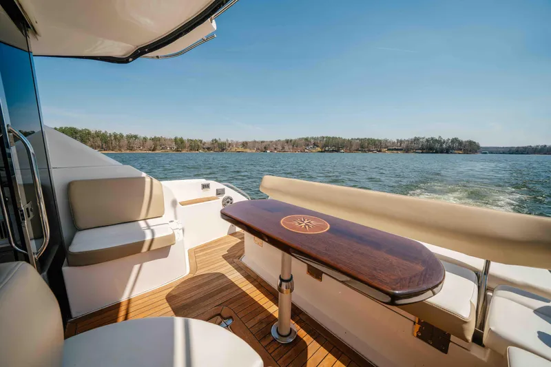 Slide: The Image of Luxurious 2012 Regal 46 Sport Coupe yacht interior with elegant seating and scenic water view. - 31