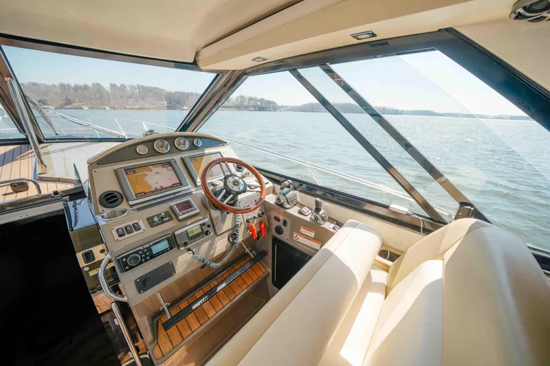 Slide: The Image of Luxurious helm of 2012 Regal 46 Sport Coupe yacht with advanced navigation controls. - 33