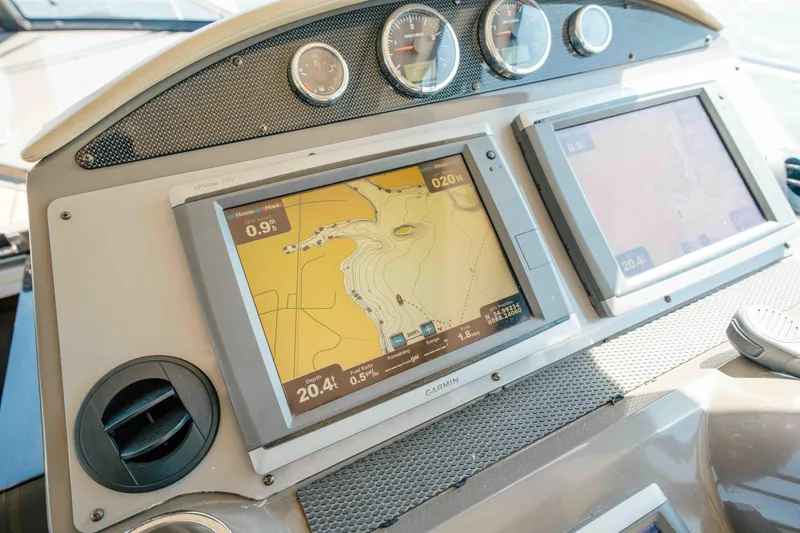 Slide: The Image of Dashboard of a 2012 Regal 46 Sport Coupe with navigation screens and gauges. - 36