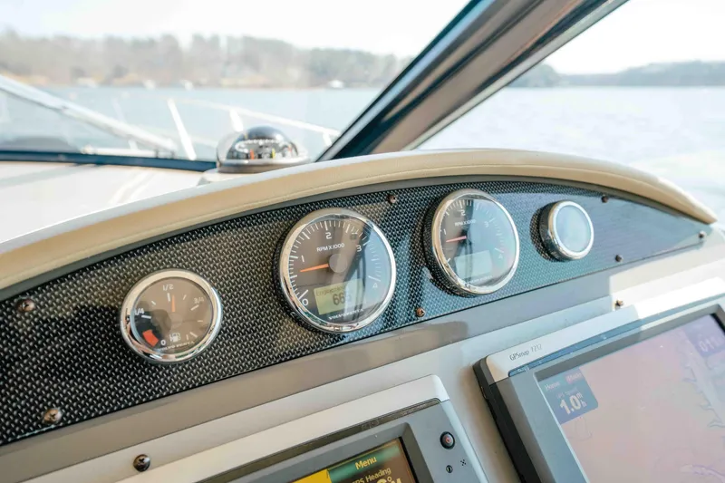 Slide: The Image of Dashboard of a 2012 Regal 46 Sport Coupe with gauges and navigation display. - 37