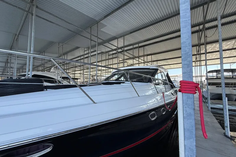 Slide: The Image of 2012 Regal 46 Sport Coupe yacht docked in a covered marina. - 4