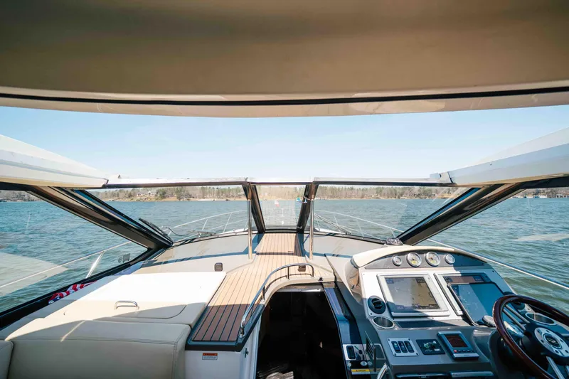 Slide: The Image of Interior view of 2012 Regal 46 Sport Coupe yacht, featuring helm and panoramic windows. - 42