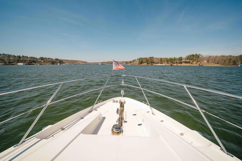 Slide: The Image of Bow view of 2012 Regal 46 Sport Coupe on a scenic lake. - 44