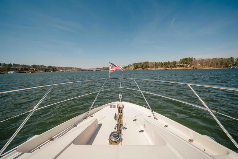 Slide: The Image of Bow view of 2012 Regal 46 Sport Coupe cruising on a scenic lake. - 45