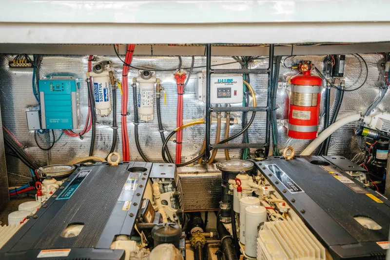 Slide: The Image of Engine room of 2012 Regal 46 Sport Coupe with dual engines and safety equipment. - 48