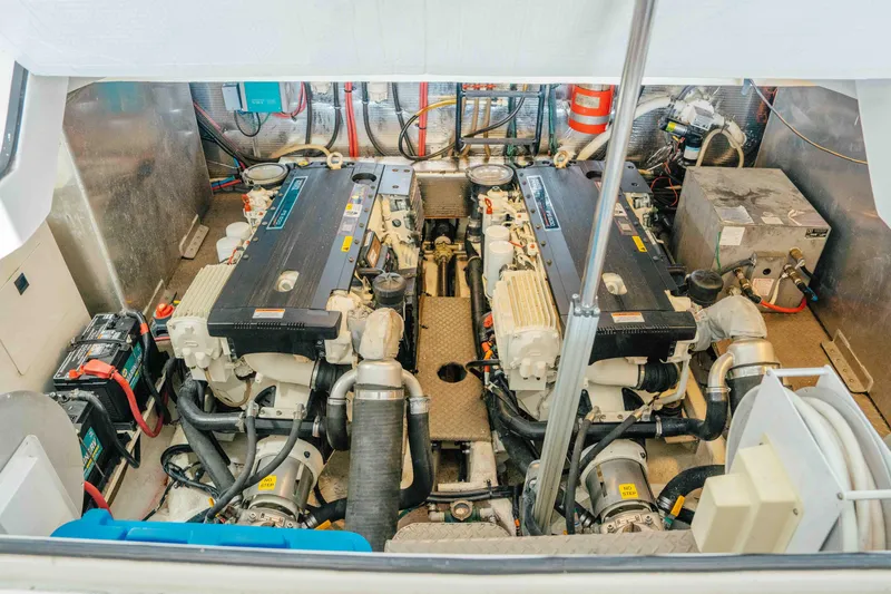 Slide: The Image of Engine room of a 2012 Regal 46 Sport Coupe, showcasing dual engines and equipment. - 50