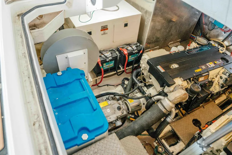 Slide: The Image of Engine room of a 2012 Regal 46 Sport Coupe with visible components and batteries. - 52