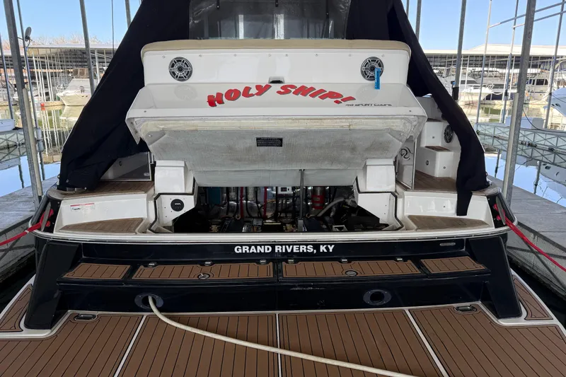 Slide: The Image of 2012 Regal 46 Sport Coupe boat docked, rear view with "Holy Ship!" text, Grand Rivers, KY. - 7