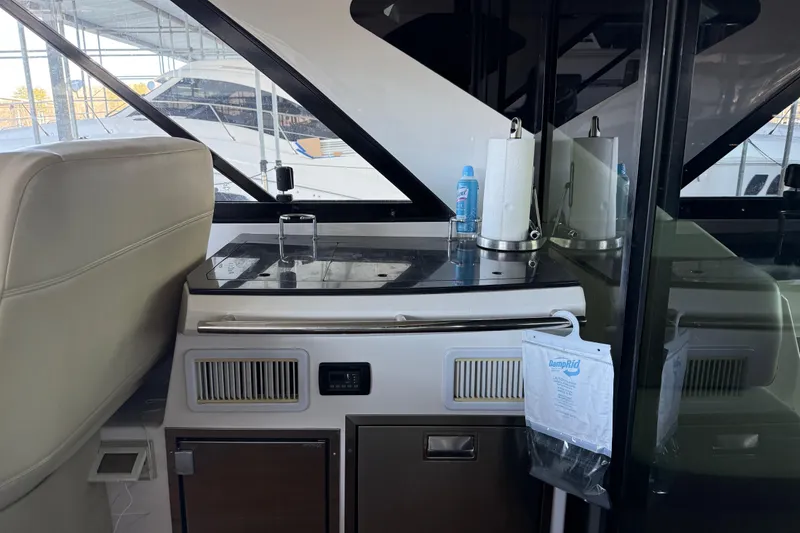 Slide: The Image of 2012 Regal 46 Sport Coupe interior with kitchenette and storage area. - 8