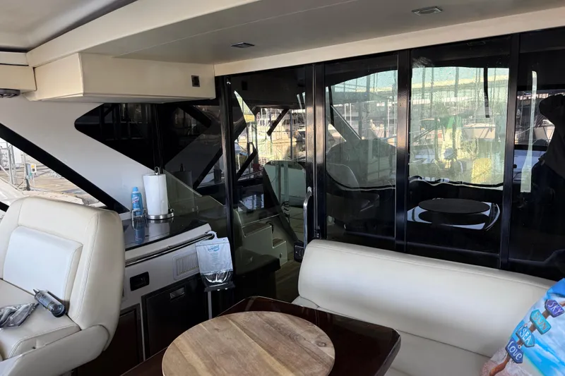 Slide: The Image of Interior view of 2012 Regal 46 Sport Coupe yacht with seating and kitchenette. - 9