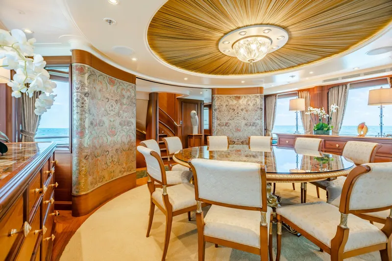 Slide: The Image of Luxurious yacht dining room with elegant decor, round table, and ocean view. Burger Custom 2010. - 10