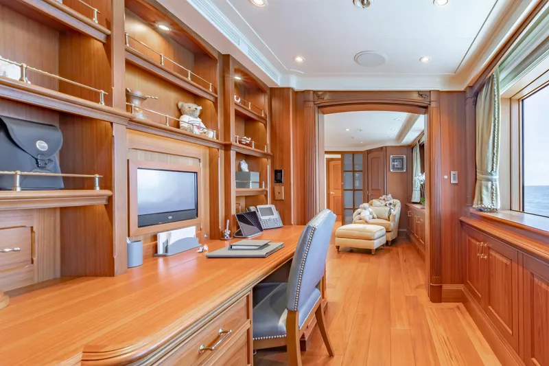 Slide: The Image of Luxurious yacht interior with wooden desk, shelves, and ocean view window. - 14