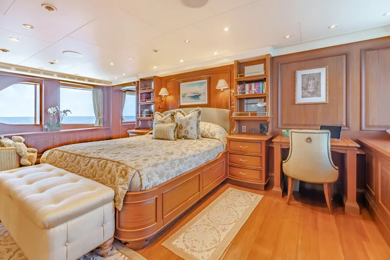 Slide: The Image of Luxurious yacht bedroom with elegant wood paneling, plush bedding, and ocean view windows. - 15