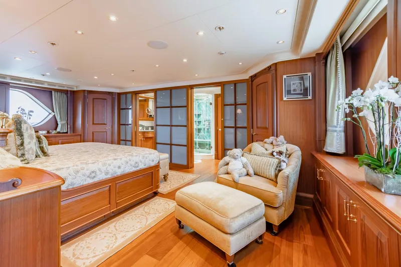 Slide: The Image of Luxurious yacht bedroom with elegant wood paneling and plush furnishings, featuring a cozy seating area. - 17