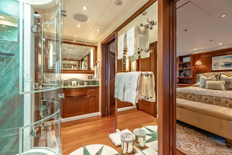 Slide: The Image of Luxurious yacht interior with elegant bathroom and cozy bedroom, featuring wood accents and plush decor. - 18