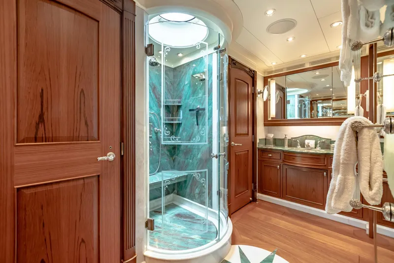 Slide: The Image of Luxurious yacht bathroom with glass shower, wooden cabinetry, and elegant fixtures, 2010 Burger Custom. - 19