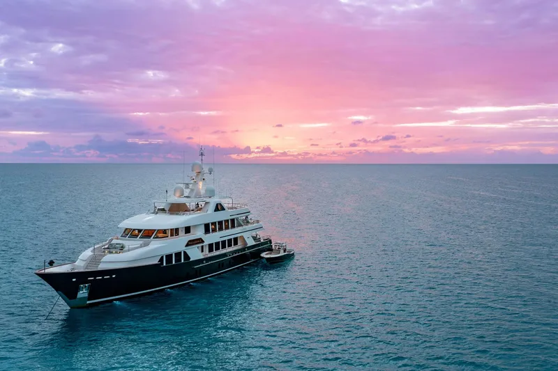 Slide: The Image of Luxurious 2010 Burger Custom yacht at sunset on tranquil ocean waters. - 21
