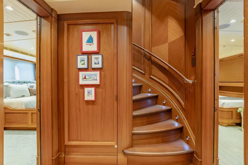 Slide: The Image of Luxurious yacht interior with curved wooden staircase and framed nautical art. - 22