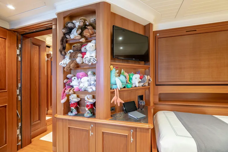 Slide: The Image of Luxurious yacht cabin with plush toys, TV, and wooden cabinetry, Burger Custom 2010 model. - 26