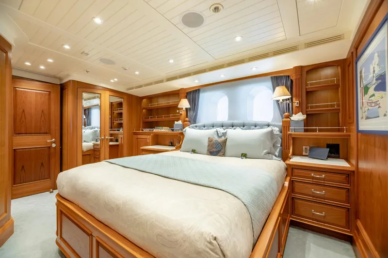 Slide: The Image of Luxurious yacht bedroom with elegant wood paneling and plush bedding, Burger Custom 2010 model. - 31