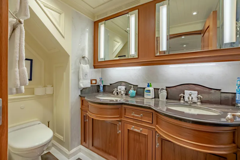 Slide: The Image of Luxurious yacht bathroom with dual sinks, wooden cabinetry, and elegant lighting. - 32