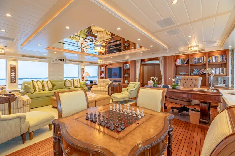 Slide: The Image of Luxurious yacht interior with elegant furnishings, chess set, and bookshelves, Burger Custom 2010 model. - 42