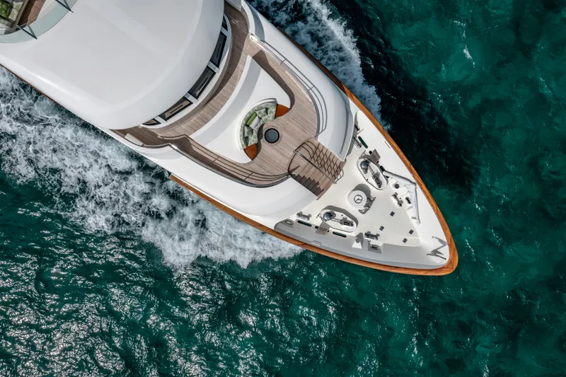 Slide: The Image of Aerial view of a 2010 Burger Custom yacht cruising on turquoise ocean waters. - 49