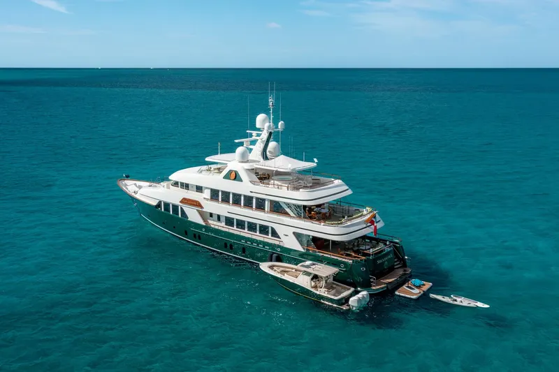 Slide: The Image of Luxurious 2010 custom Burger yacht anchored in clear blue ocean waters. - 51