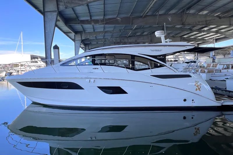 Slide: The Image of 2017 Sea Ray Sundancer 400 yacht docked under a covered marina. - 1