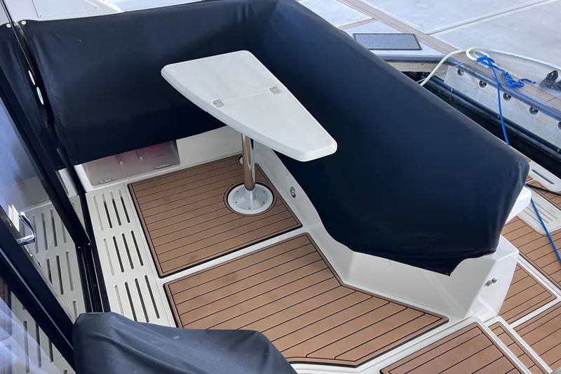 Slide: The Image of 2017 Sea Ray Sundancer 400 cockpit with teak flooring and covered seating area. - 10