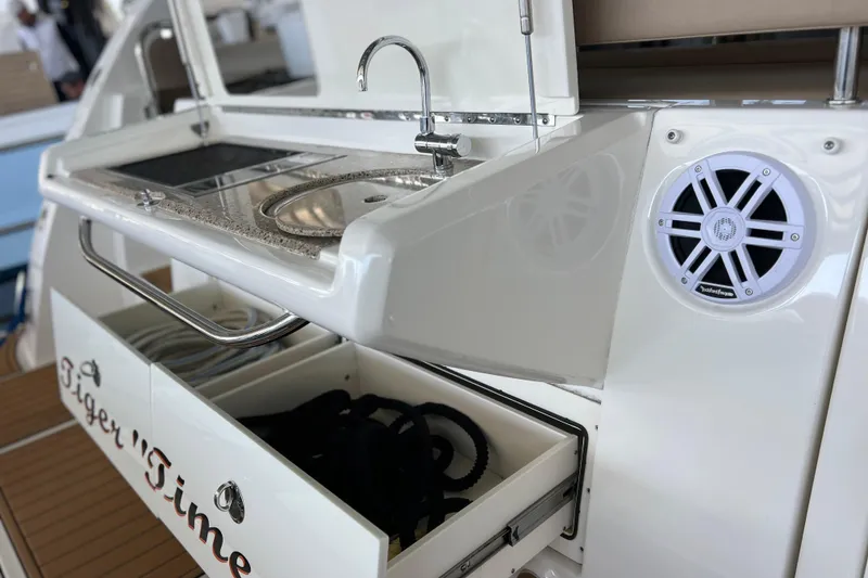 Slide: The Image of 2017 Sea Ray Sundancer 400 yacht with outdoor sink, speaker, and storage drawer. - 13