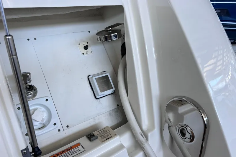 Slide: The Image of 2017 Sea Ray Sundancer 400 boat compartment with control panel and hose. - 14