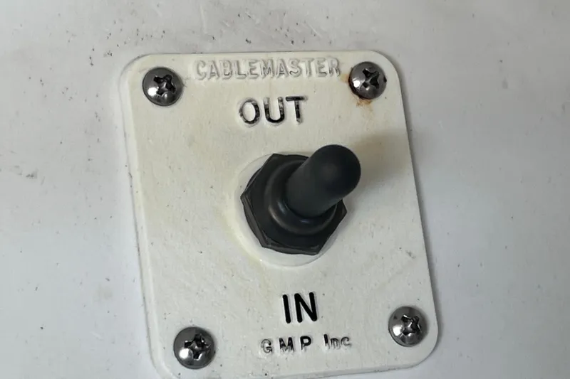Slide: The Image of CableMaster switch on 2017 Sea Ray Sundancer 400 boat, labeled "OUT" and "IN." - 15