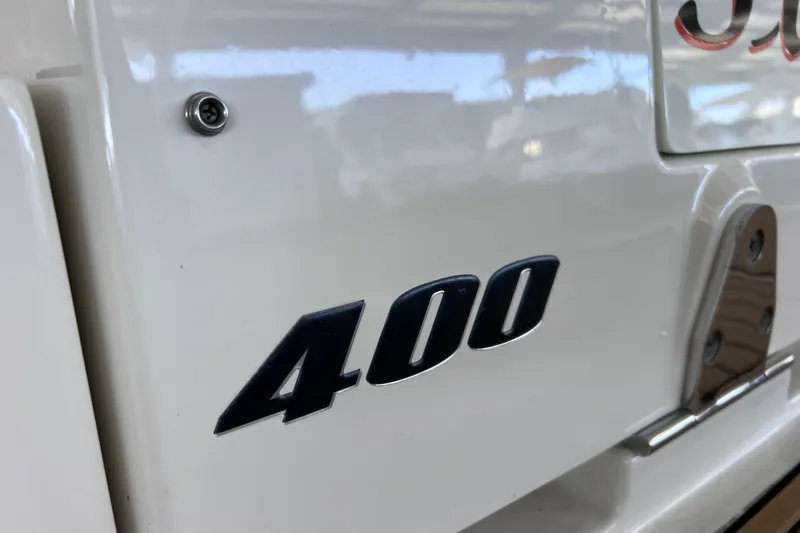 Slide: The Image of 2017 Sea Ray Sundancer 400 boat emblem on white surface. - 17