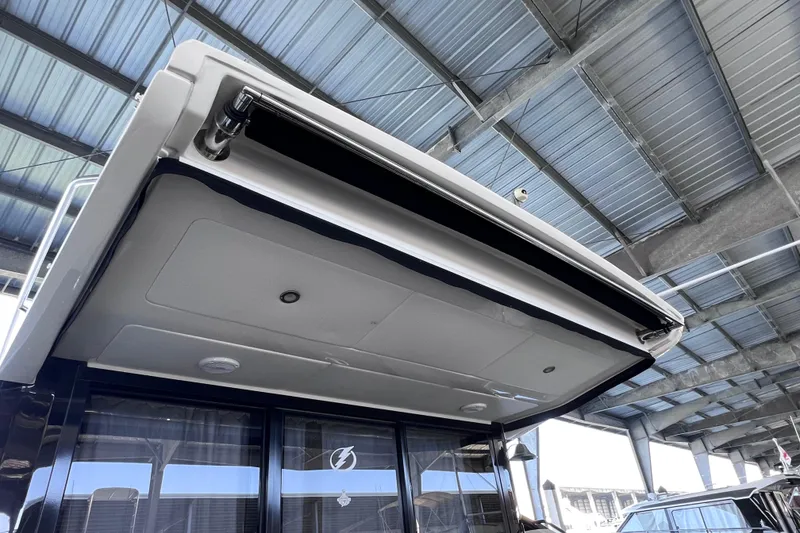 Slide: The Image of 2017 Sea Ray Sundancer 400 yacht under a metal roof structure. - 19