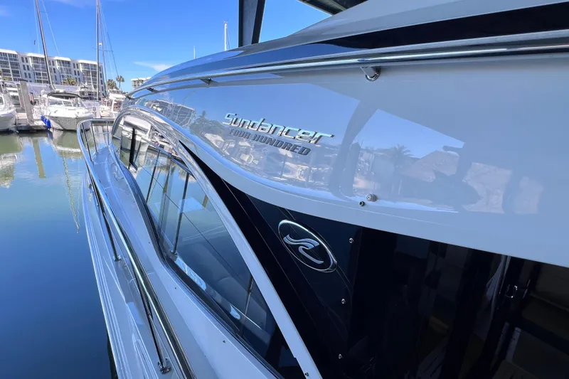 Slide: The Image of 2017 Sea Ray Sundancer 400 yacht docked in marina, reflecting clear blue sky. - 22