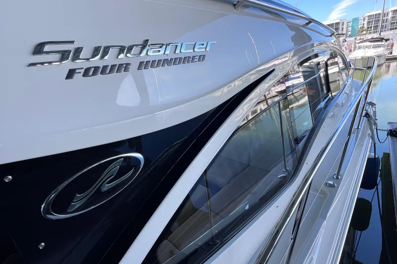 Slide: The Image of 2017 Sea Ray Sundancer 400 yacht docked, showcasing sleek design and branding. - 23
