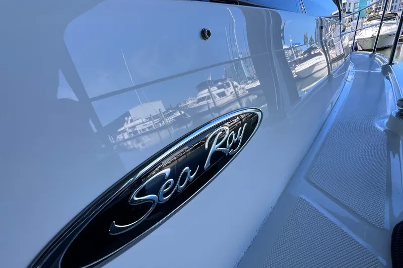 Slide: The Image of 2017 Sea Ray Sundancer 400 yacht with reflective hull and logo in marina. - 24