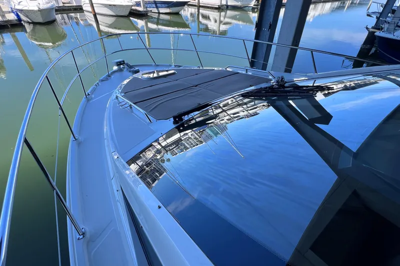 Slide: The Image of 2017 Sea Ray Sundancer 400 yacht docked, reflecting water and marina surroundings. - 26