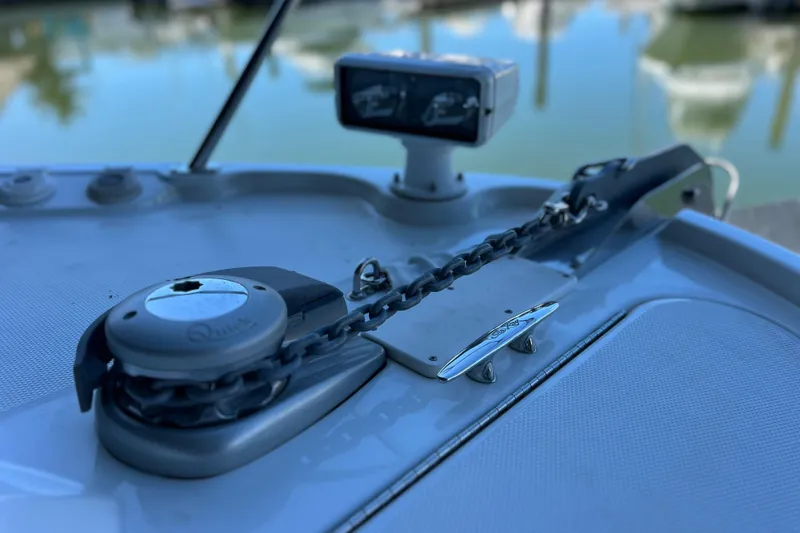 Slide: The Image of 2017 Sea Ray Sundancer 400 anchor chain and winch on deck, marina background. - 30