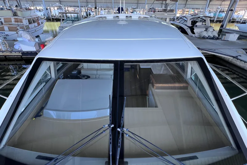 Slide: The Image of 2017 Sea Ray Sundancer 400 yacht docked in a marina, showcasing sleek design and spacious interior. - 32