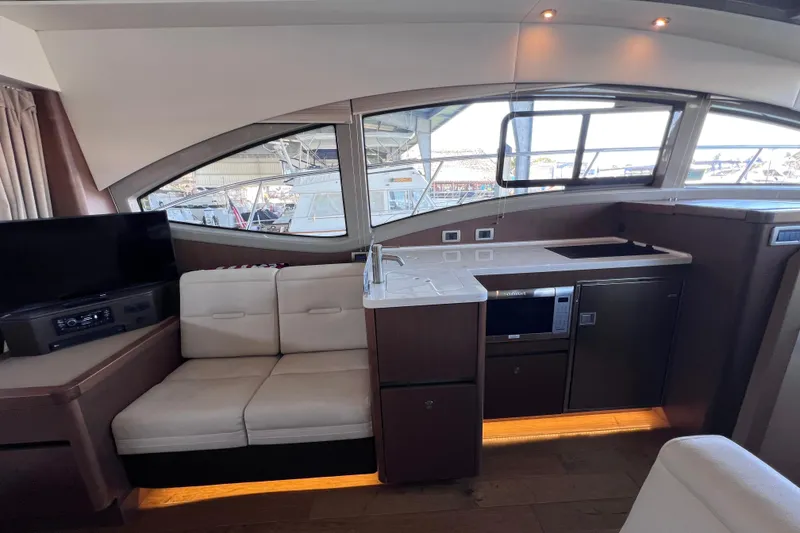 Slide: The Image of Interior of 2017 Sea Ray Sundancer 400 yacht with modern kitchen and seating area. - 38