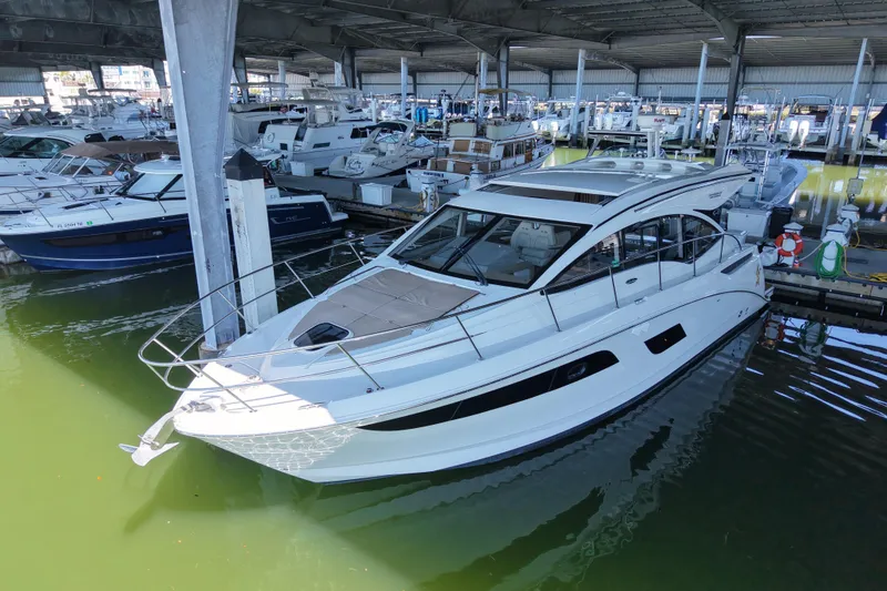 Slide: The Image of 2017 Sea Ray Sundancer 400 yacht docked in a marina under a covered structure. - 4