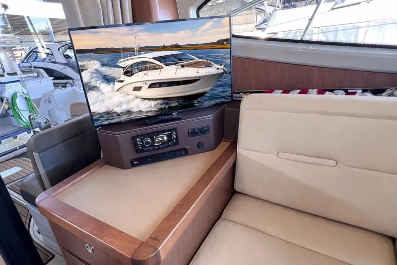 Slide: The Image of Interior of a 2017 Sea Ray Sundancer 400 yacht with a TV displaying the boat. - 42