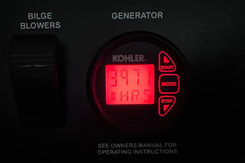 Slide: The Image of Control panel of a 2017 Sea Ray Sundancer 400, displaying generator hours. - 45
