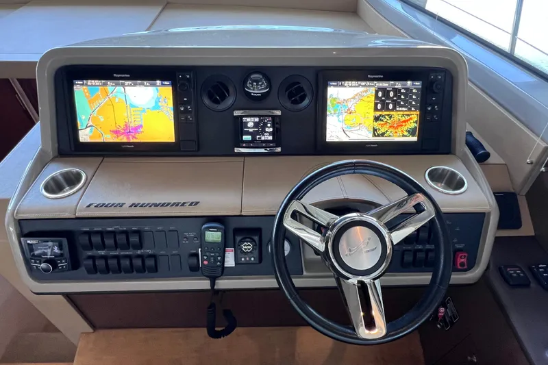Slide: The Image of 2017 Sea Ray Sundancer 400 helm with navigation screens and controls. - 49