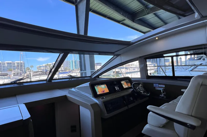Slide: The Image of Interior view of 2017 Sea Ray Sundancer 400 yacht helm with marina backdrop. - 62