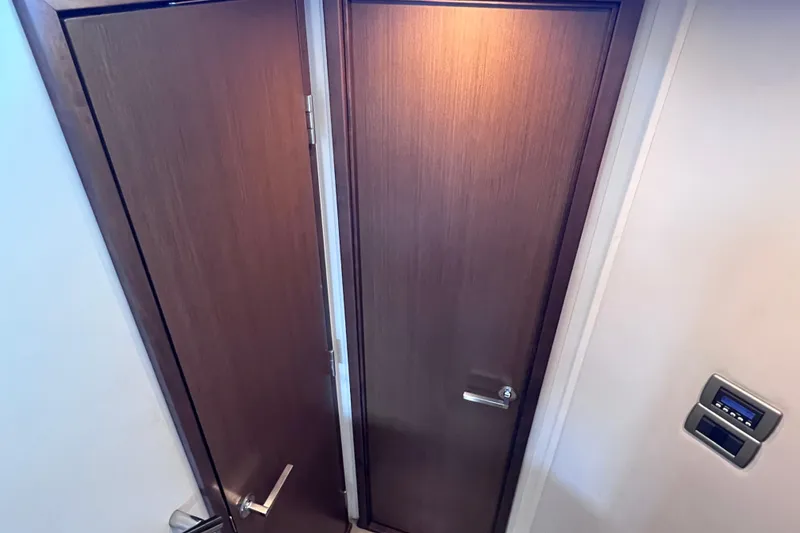 Slide: The Image of Interior doors of 2017 Sea Ray Sundancer 400 yacht, featuring sleek wooden design. - 66