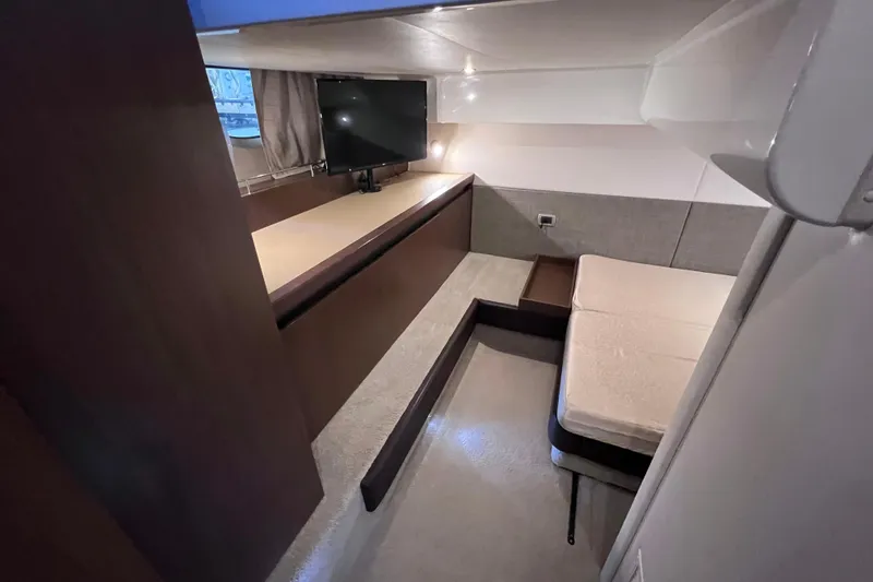 Slide: The Image of 2017 Sea Ray Sundancer 400 cabin interior with bed, TV, and modern furnishings. - 78