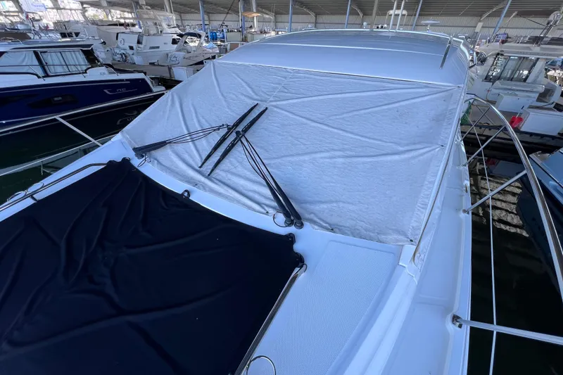 Slide: The Image of 2017 Sea Ray Sundancer 400 yacht with covered windshield in marina. - 93